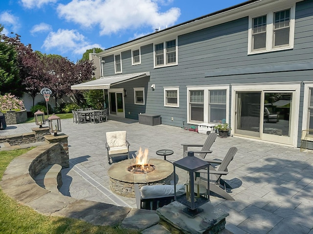 exterior space featuring a patio area and an outdoor fire pit