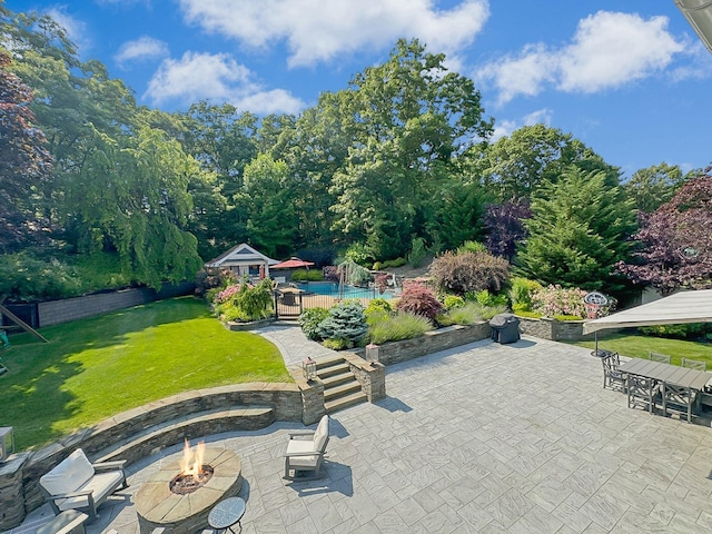 view of patio / terrace with an outdoor structure and a fire pit