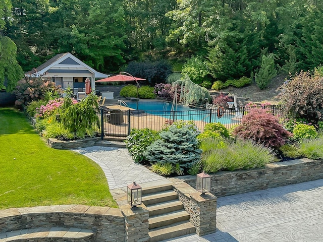 view of pool with a yard and a patio area