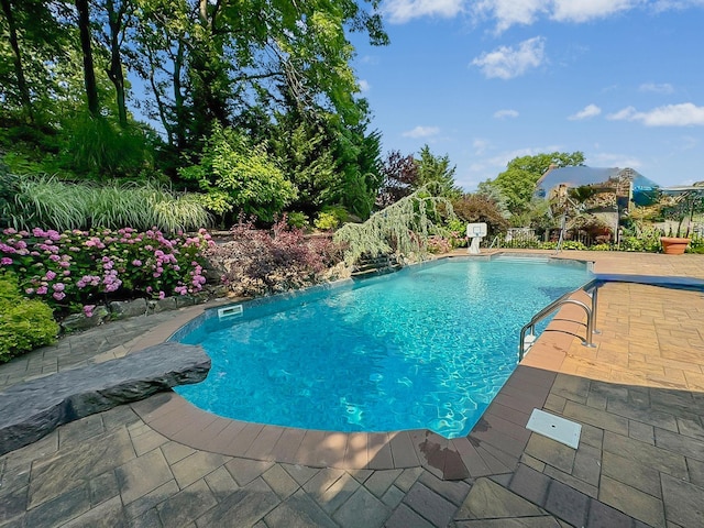 view of pool featuring pool water feature and a patio area