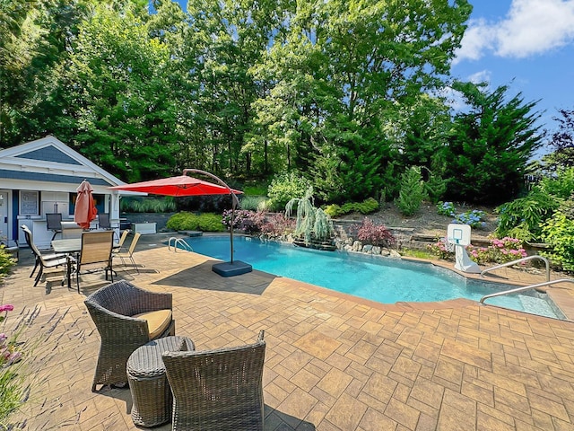 view of pool with a patio area and an outdoor structure