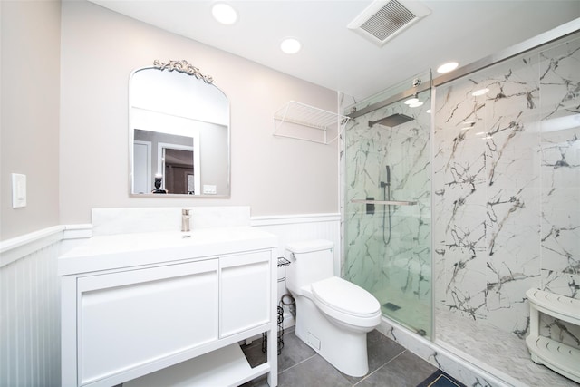 bathroom featuring vanity, walk in shower, tile patterned floors, and toilet