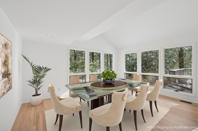 sunroom / solarium featuring vaulted ceiling