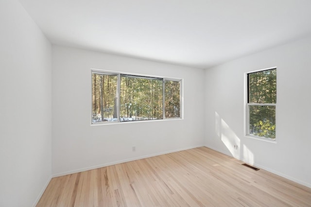 unfurnished room featuring light hardwood / wood-style floors