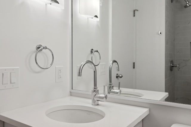 bathroom featuring vanity and a tile shower