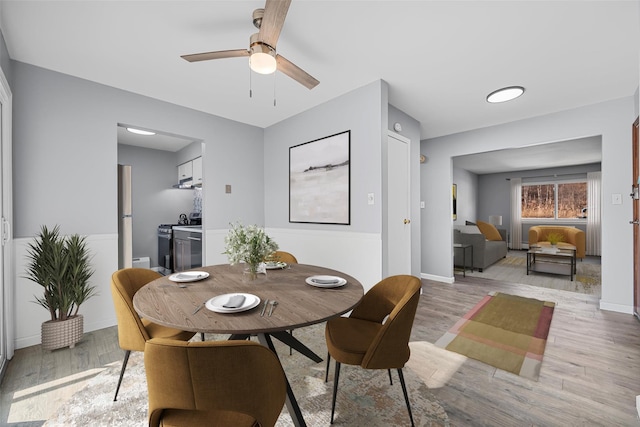 dining room with ceiling fan and light hardwood / wood-style floors