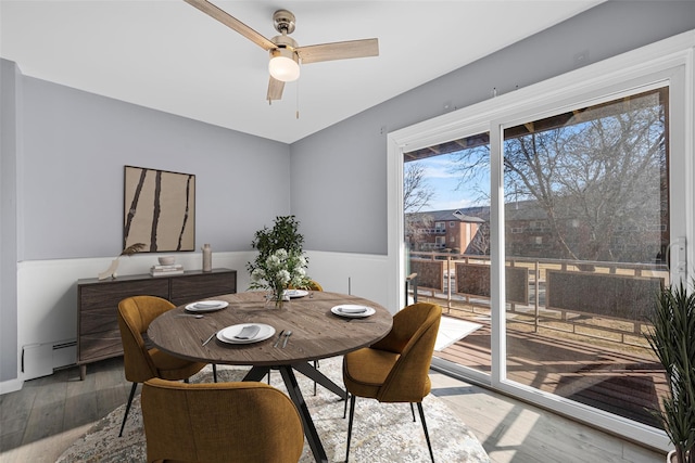 dining area with ceiling fan, hardwood / wood-style floors, and baseboard heating