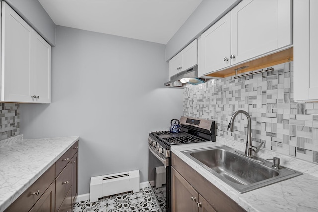 kitchen with sink, baseboard heating, white cabinetry, stainless steel gas range oven, and light stone countertops