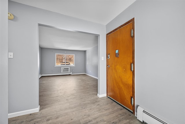 entrance foyer with a baseboard radiator and light hardwood / wood-style flooring