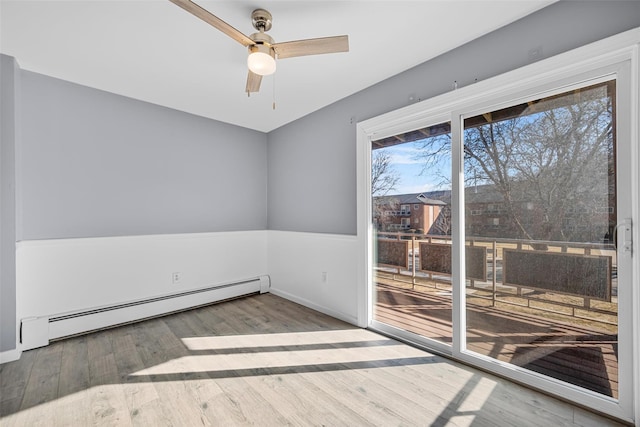 empty room with ceiling fan, a baseboard radiator, and wood-type flooring