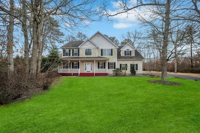 view of front facade with covered porch and a front yard