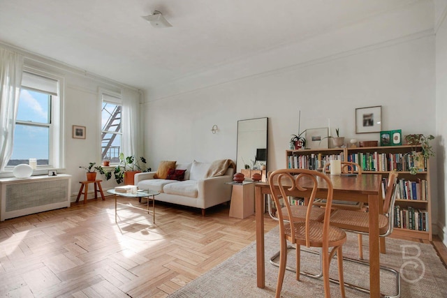 dining room with radiator heating unit and light parquet floors