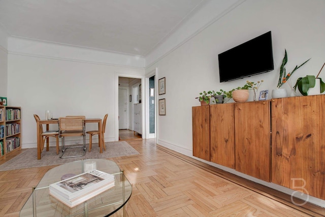 living room featuring crown molding and light parquet flooring