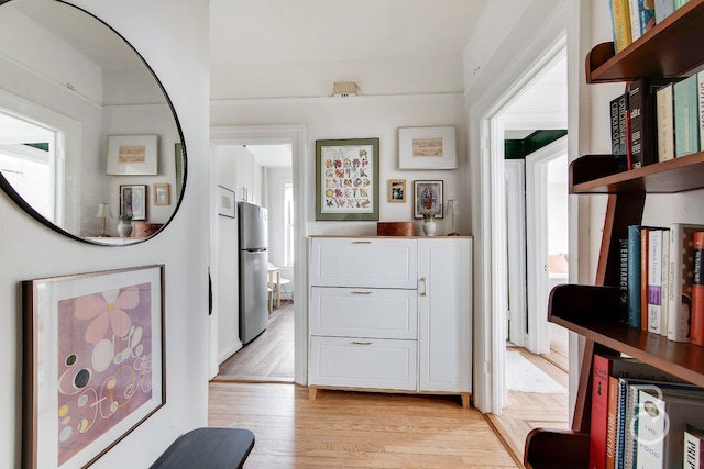 hall with light hardwood / wood-style floors