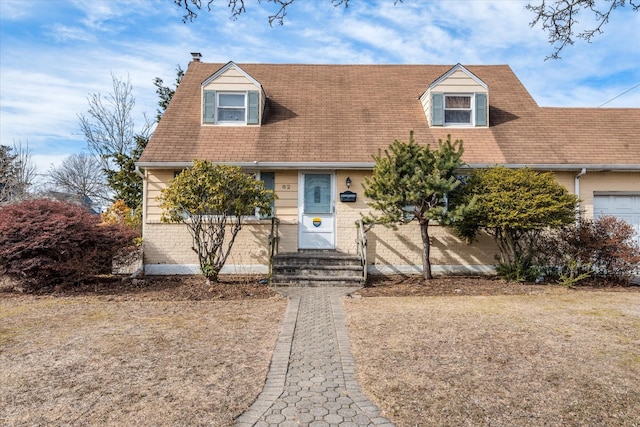 cape cod house featuring a chimney