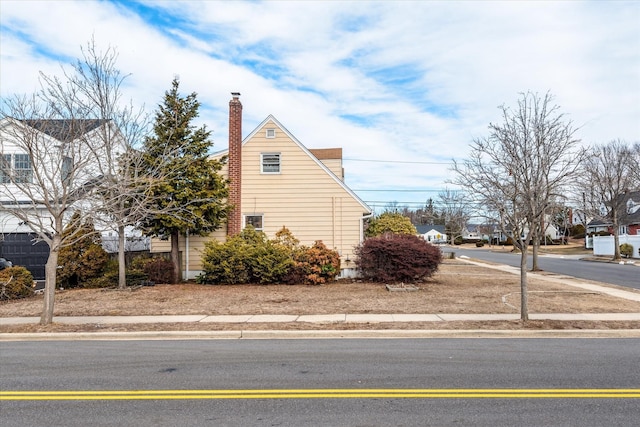 view of side of home with a chimney