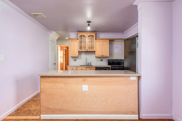 kitchen with a peninsula, light countertops, light brown cabinetry, black appliances, and glass insert cabinets