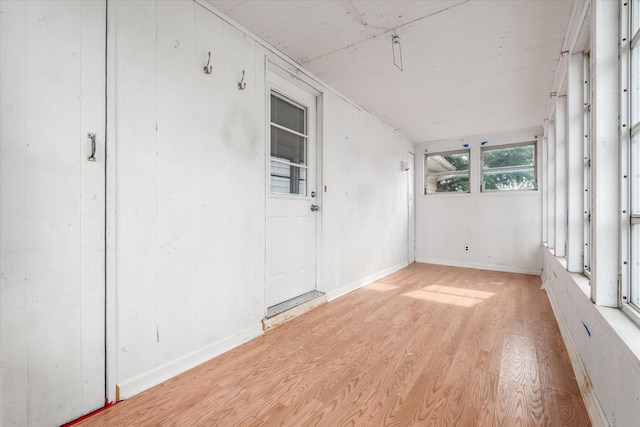 interior space featuring light wood-type flooring and baseboards