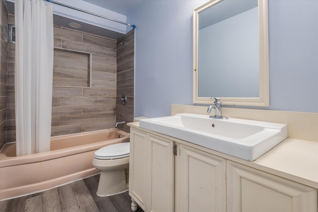 bathroom featuring vanity, wood finished floors, toilet, and shower / bathtub combination with curtain