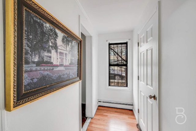 corridor featuring a baseboard radiator and wood-type flooring