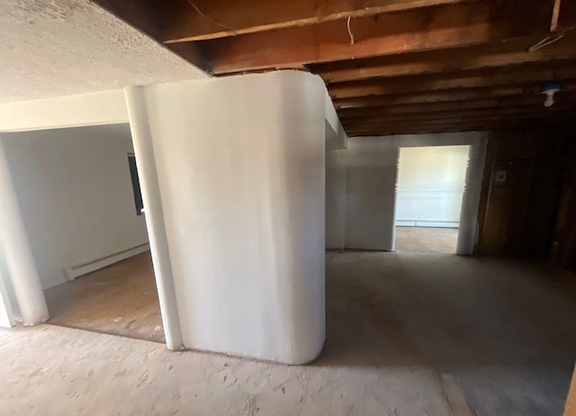 basement featuring a baseboard heating unit