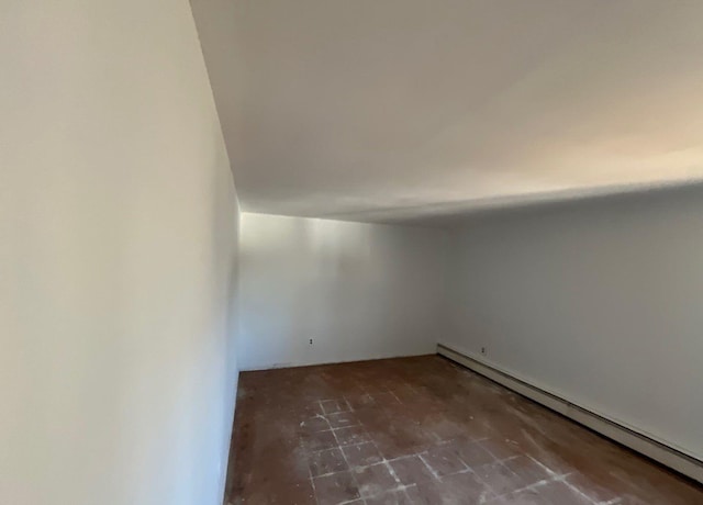 empty room featuring a baseboard radiator