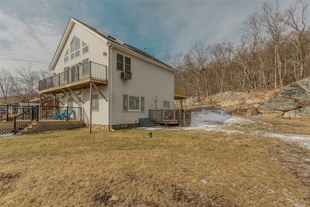 rear view of property featuring a yard and a deck