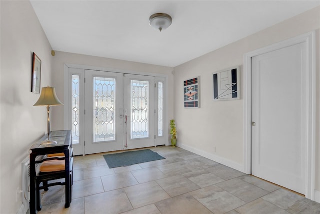 foyer entrance featuring light tile patterned floors and french doors