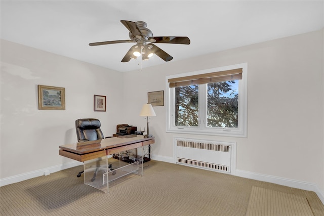 home office with radiator heating unit, light colored carpet, and ceiling fan