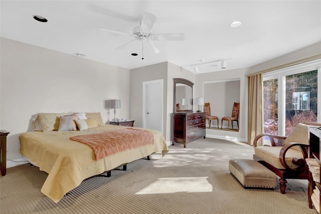 carpeted bedroom with track lighting and ceiling fan