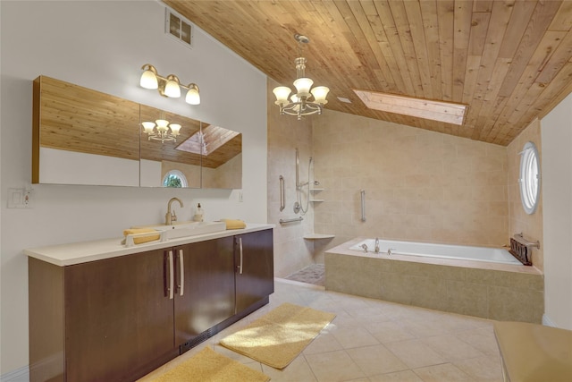 bathroom with tiled tub, wood ceiling, vanity, vaulted ceiling, and tile patterned floors