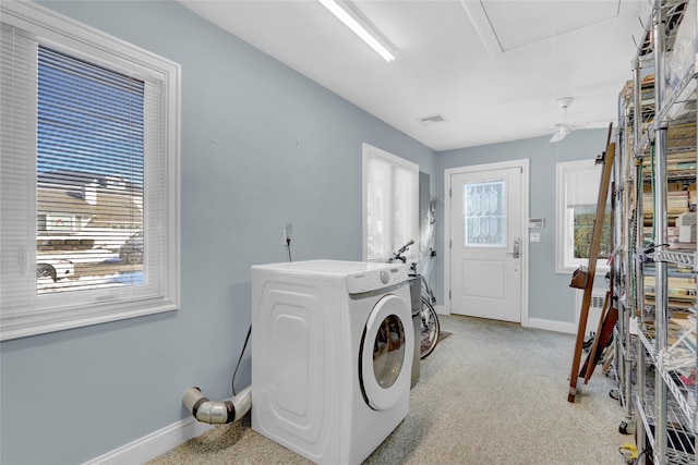 clothes washing area featuring washer / clothes dryer and light carpet