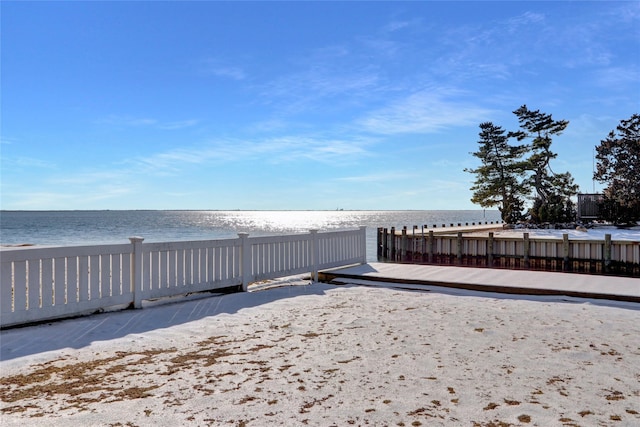 view of yard with a water view and a beach view