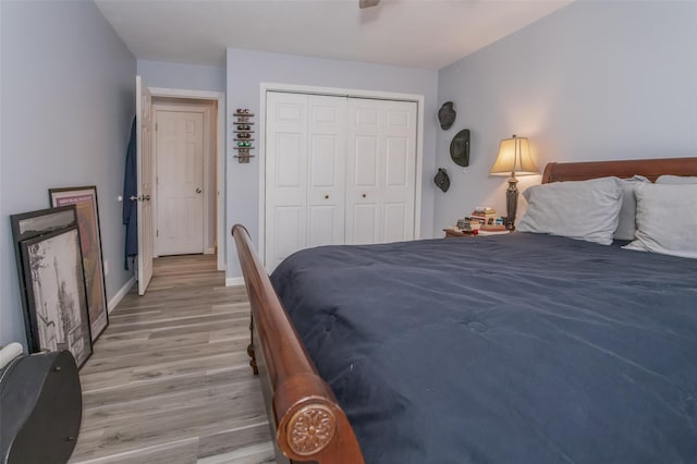 bedroom featuring ceiling fan, light hardwood / wood-style floors, and a closet