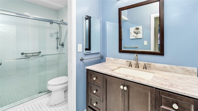 bathroom featuring vanity, toilet, a shower with shower door, and tile patterned flooring