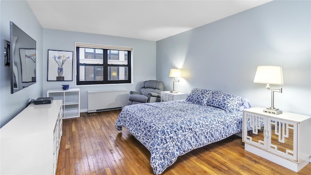 bedroom featuring dark wood-type flooring and radiator heating unit