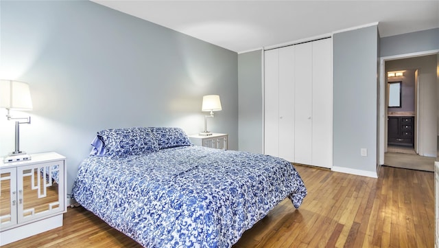 bedroom with hardwood / wood-style flooring and a closet