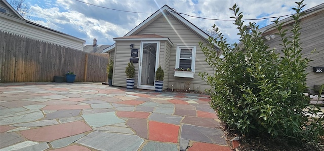back of house with fence and a patio area