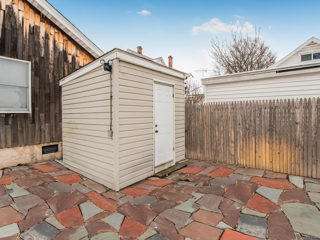 view of shed with fence