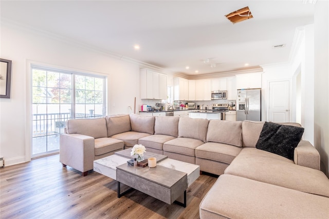 living room featuring ornamental molding and hardwood / wood-style floors