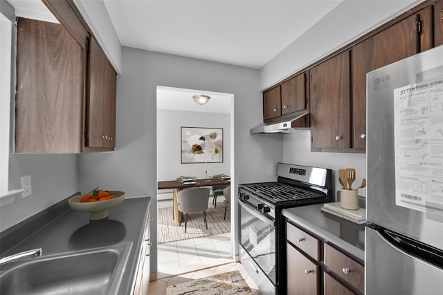 kitchen with stainless steel appliances, dark brown cabinets, and sink