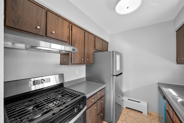 kitchen featuring appliances with stainless steel finishes, sink, light tile patterned floors, and baseboard heating