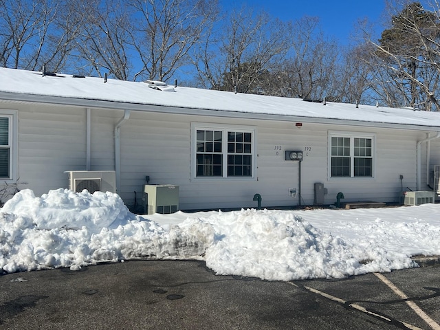 view of snow covered rear of property