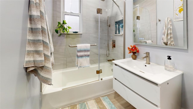 bathroom featuring vanity and combined bath / shower with glass door