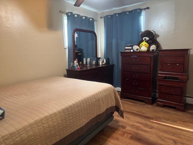 bedroom with hardwood / wood-style floors and ceiling fan