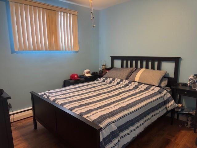 bedroom with dark wood-type flooring and a baseboard radiator