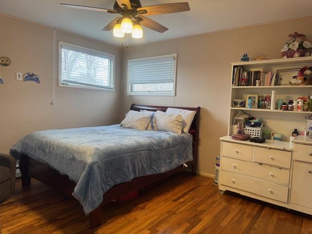 bedroom with dark wood-type flooring and ceiling fan