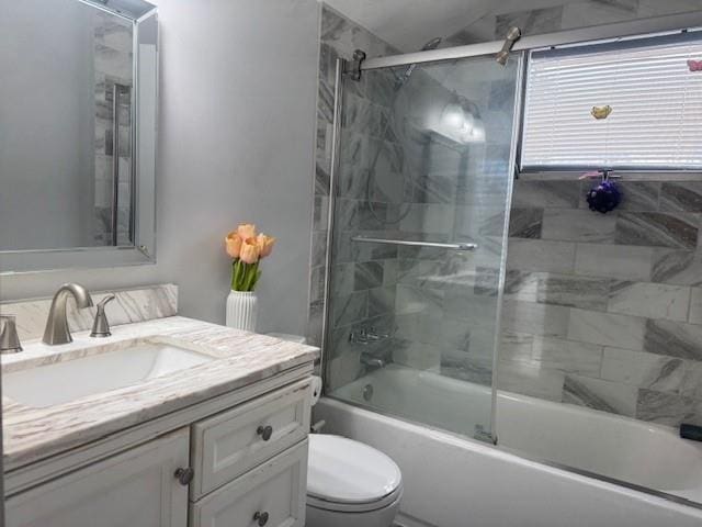 full bathroom featuring toilet, vanity, and shower / bath combination with glass door