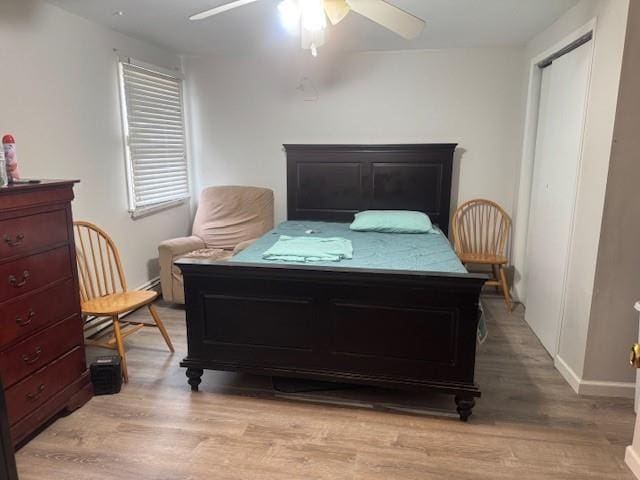 bedroom with ceiling fan and light hardwood / wood-style floors