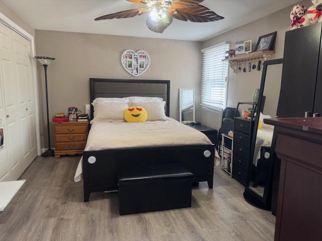 bedroom with hardwood / wood-style flooring, a closet, and ceiling fan